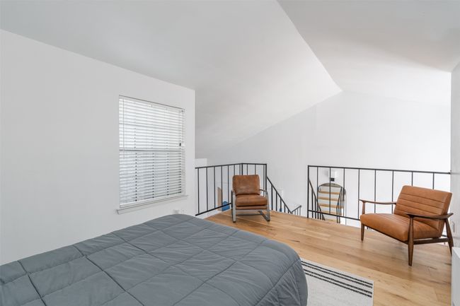 Bedroom featuring wood finished floors and lofted ceiling | Image 12