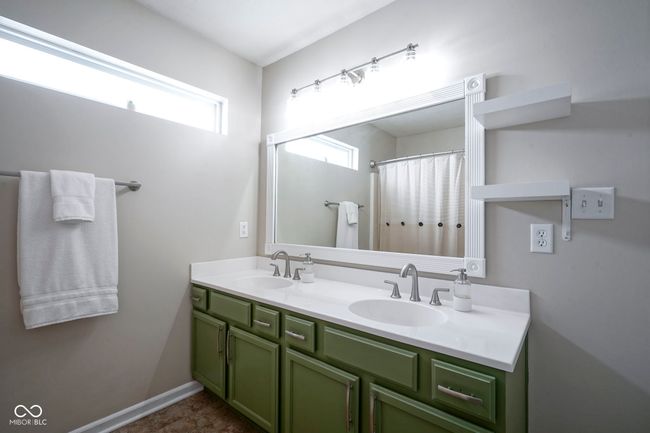 full bath featuring double vanity and a sink | Image 23