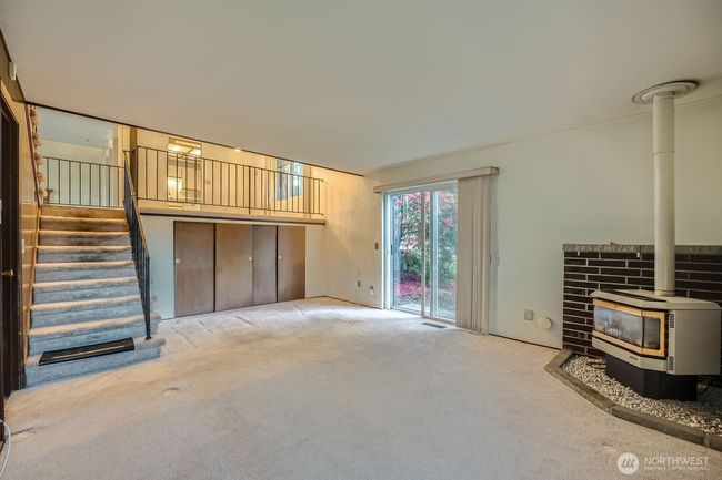 Lower level has gas burning fireplace, sliding glass door to backyard and storage cabinets with crawl space access. | Image 20