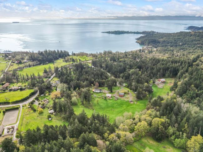 Aerial view of property's location with a nearby body of water and a forest | Image 43