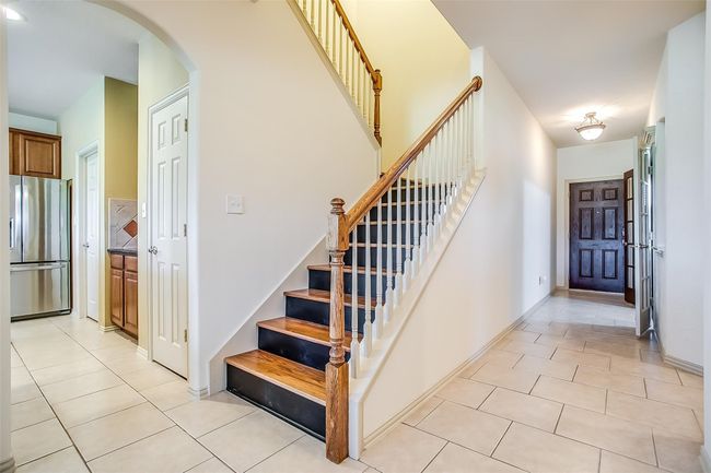 Stairs featuring arched walkways & tile floors. | Image 9
