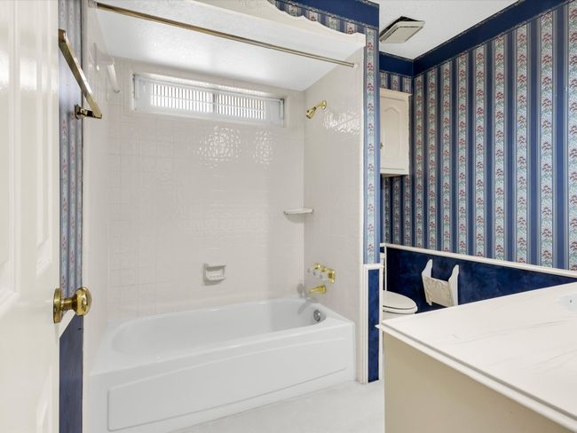 Large tub /shower combo with window allows for privacy as well as natural light. | Image 32