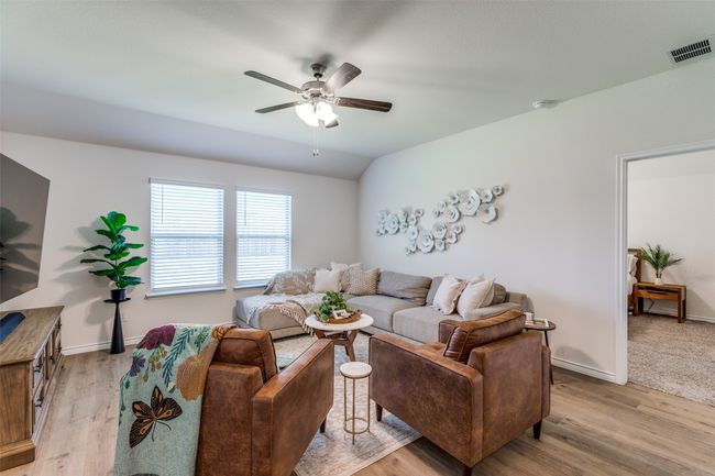 View 2 with a ceiling fan, light laminated wood-plank floors. | Image 5