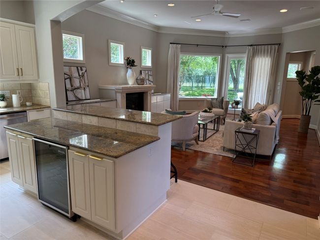 Kitchen featuring wine cooler, plenty of natural light, a kitchen island, stainless steel appliance with eat-in dining area | Image 15