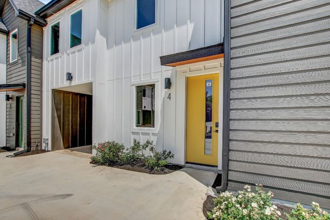 Property entrance with board and batten siding and a patio | Image 29