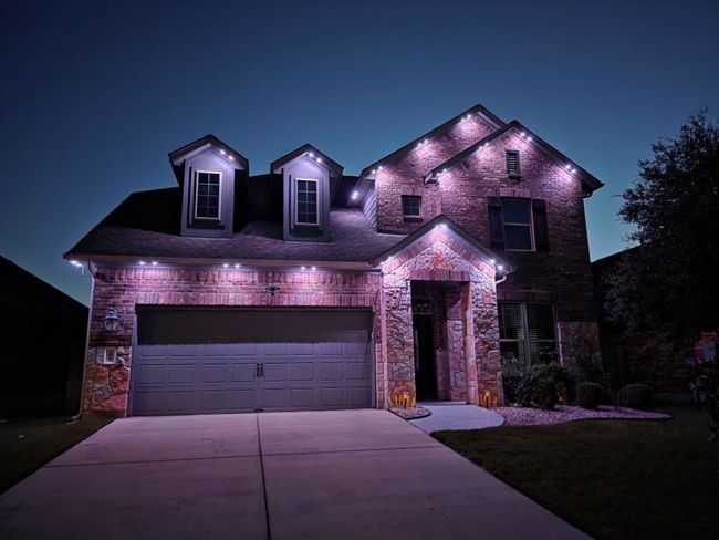 View of front facade featuring permanent undermount outdoor lighting. can change colors for different occasions. | Image 31