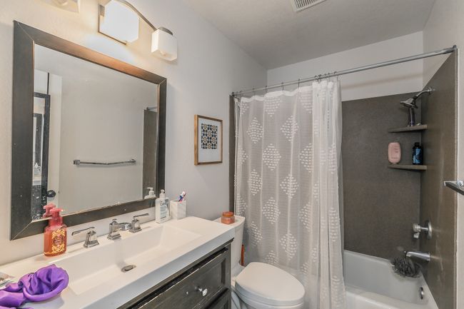 Unit 4900 Another view of Full bathroom featuring shower / bathtub combination with curtain, vanity, and toilet | Image 18
