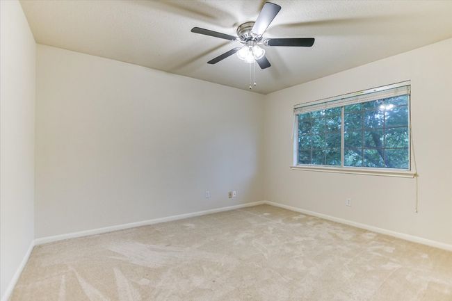 Spare room featuring light carpet, baseboards, and ceiling fan | Image 15