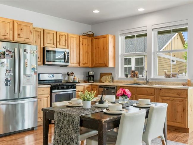 Kitchen featuring stainless steel appliances, light wood finished floors, light countertops, recessed lighting, and light brown cabinets | Image 14
