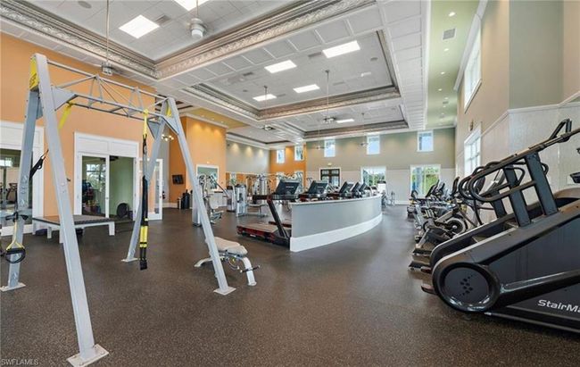 Exercise room featuring a towering ceiling and a healthy amount of sunlight | Image 24