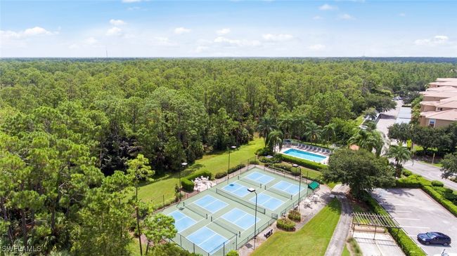 Bird's eye view of a heavily wooded area and a pool | Image 35
