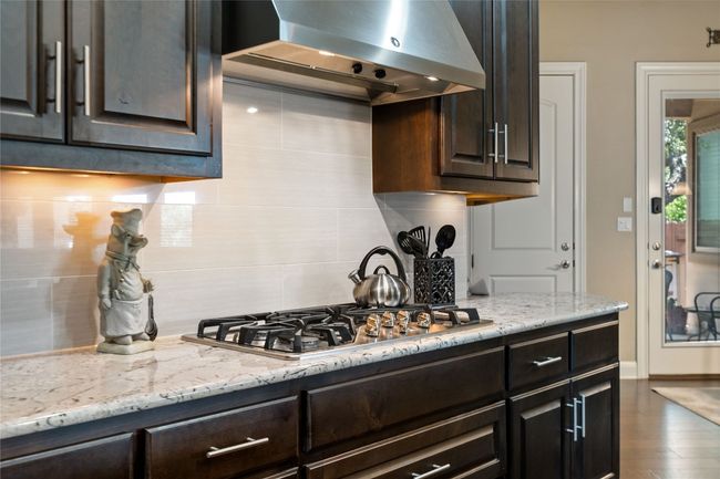 Kitchen Features Granite Countertops, Gas Cooking and Center Island | Image 13