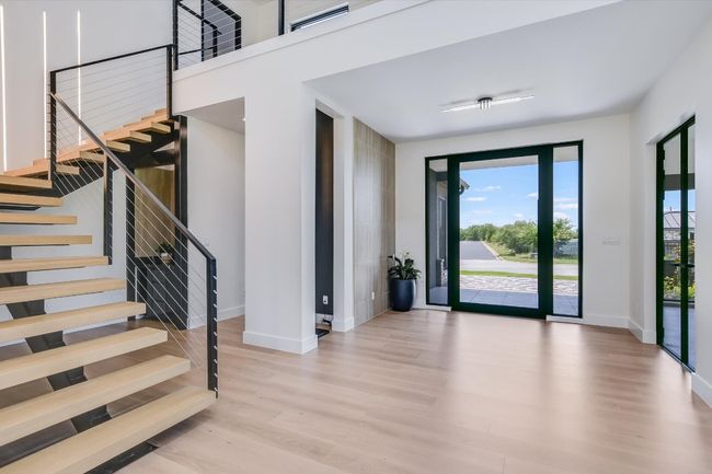 Entrance foyer featuring wood finished floors and modern floating stairs | Image 9