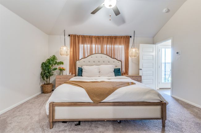 Bedroom with baseboards, carpet flooring, ceiling fan, and lofted ceiling | Image 15