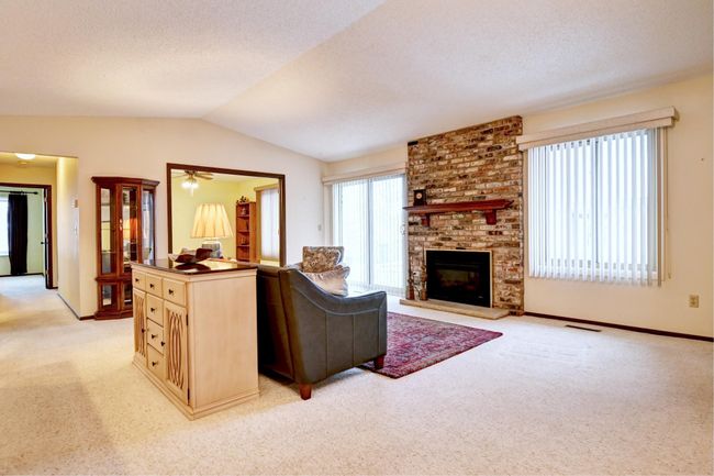 Beyond living area is a den with double doors | Image 7