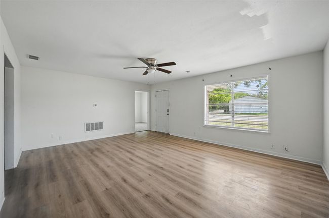 Spare room with wood finished floors and baseboards | Image 16