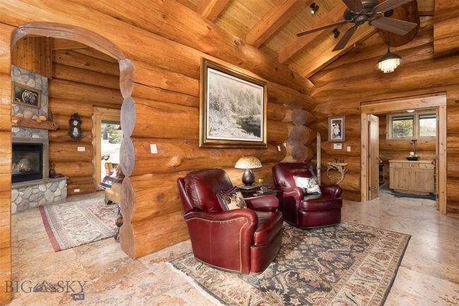 Main level primary bedroom entryway with dual arches accessing primary bedroom, bathroom and walk-in closet. | Image 14