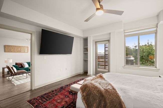 Bedroom featuring wood finished floors, access to exterior, and baseboards | Image 15