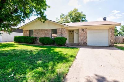 Single story home with a garage and a front yard | Image 1