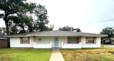 Ranch-style home with a front lawn | Image 1