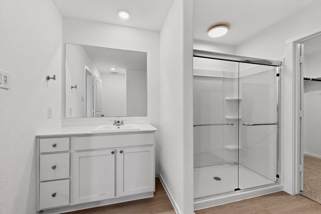Full bathroom with a shower stall, wood finished floors, and vanity | Image 20