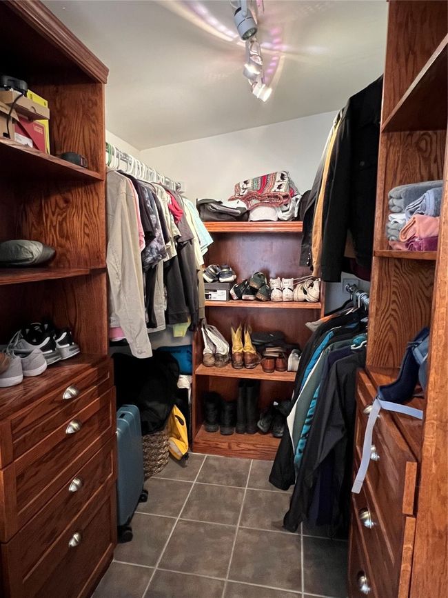 Spacious closet with dark tile patterned flooring | Image 18