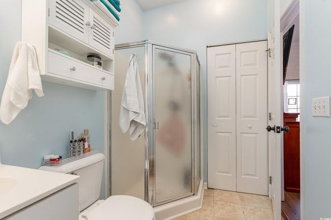 Full bath featuring tile patterned floors, a shower stall, toilet, and vanity | Image 19