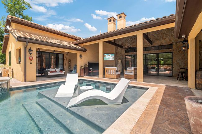 Patio to left has double iron doors that lead into primary bedroom. | Image 6