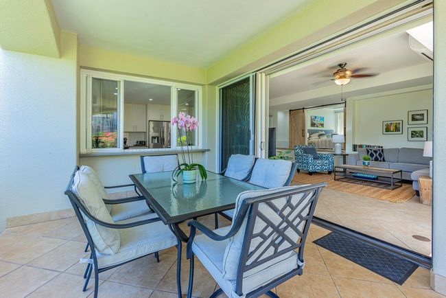 The great room has large sliding doors that span the length of the wall leading out to the expansive | Image 26
