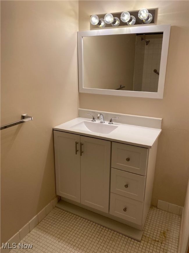 Bathroom with tile patterned flooring, baseboards, and vanity | Image 7