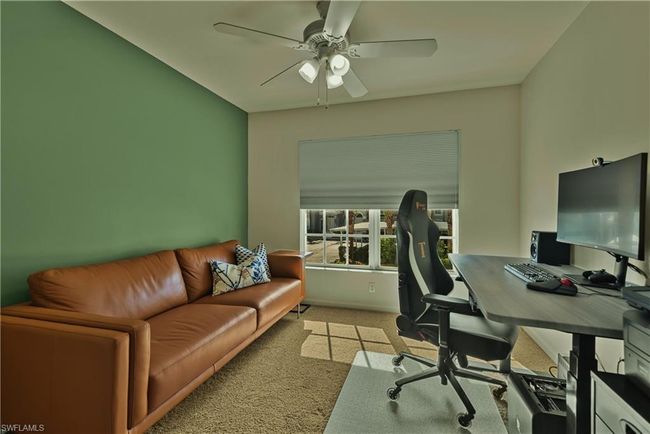 Carpeted office featuring ceiling fan | Image 13