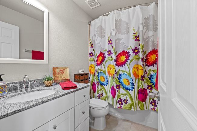 Upstairs bathroom located off the bonus room and between both secondary bedrooms | Image 24