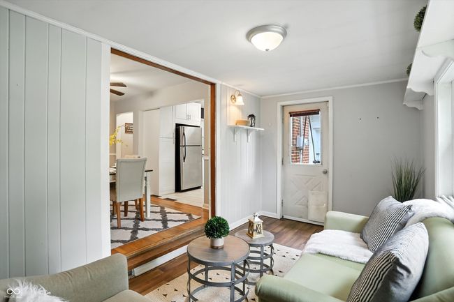 living area with light wood finished floors and ornamental molding | Image 21