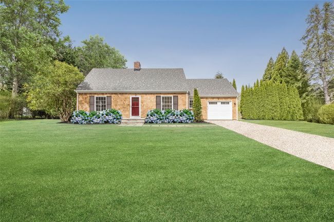 Ranch-style home with a chimney, driveway, roof with shingles, a front yard, and an attached garage | Image 8