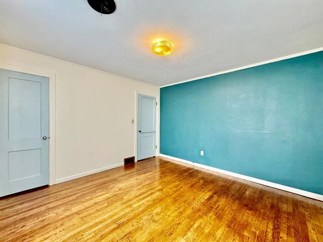 Empty room with wood finished floors and crown molding | Image 18