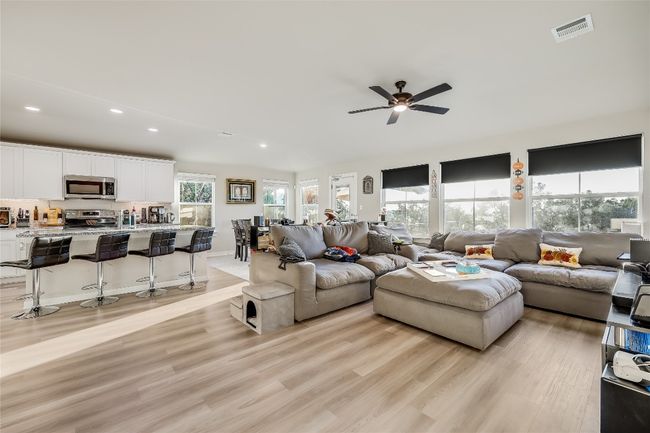 Living area featuring recessed lighting, light wood-style flooring, and ceiling fan | Image 12