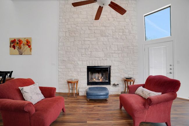 Living area with stone fireplace and a towering ceiling | Image 7
