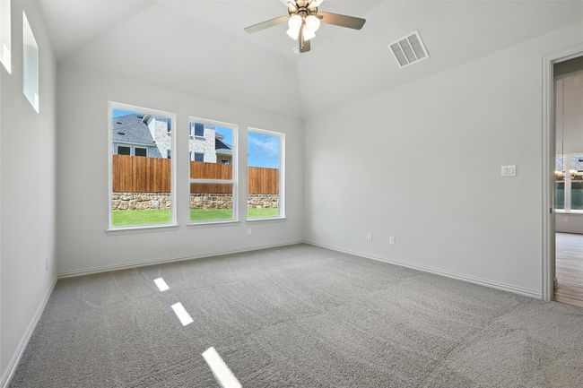 Spare room featuring carpet floors, ceiling fan, and vaulted ceiling | Image 18