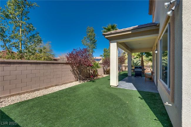 View of yard with a fenced backyard and a patio area | Image 63