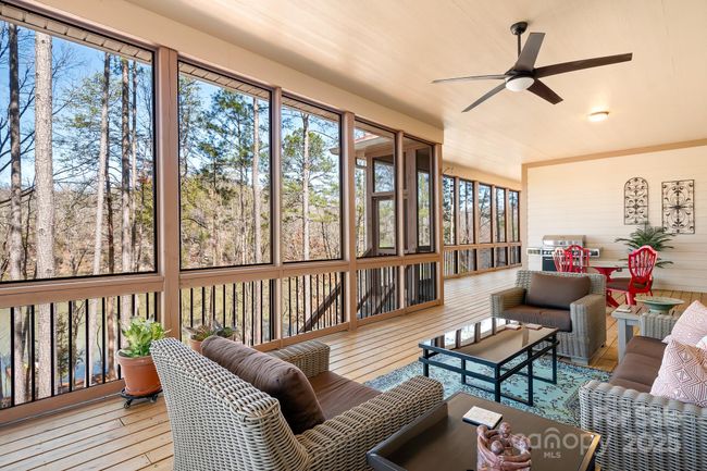 Covered Screened in space with beautiful decking, ceiling fans and sweeping views of Lake Adger, your private floaiting dock, soaring pine trees and more! Perfect for Entertaining. | Image 29