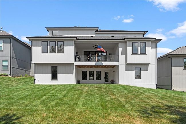 Back of property with a yard and a balcony | Image 37