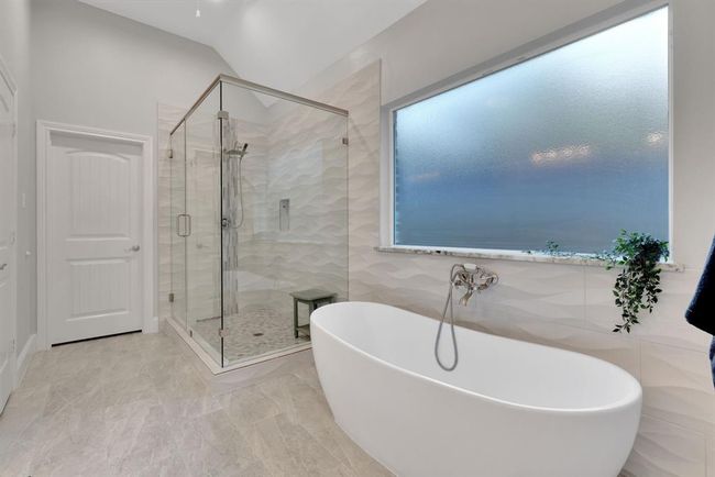 With its graceful lines and calming presence, this soaking tub adds a touch of everyday luxury to the primary bath. | Image 29
