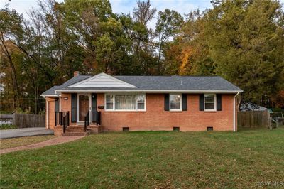 View of front facade with a front lawn | Image 1