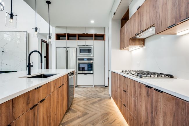 Kitchen featuring appliances with stainless steel finishes, modern cabinets, light countertops, and recessed lighting | Image 18