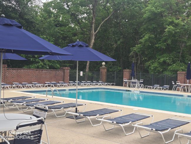 With many chairs, umbrellas, and clubhouse chairs | Image 32