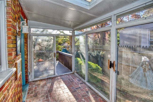 Unfurnished sunroom featuring plenty of natural light and a skylight | Image 7