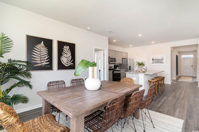 Dining area featuring baseboards, wood finished floors, and recessed lighting | Image 9