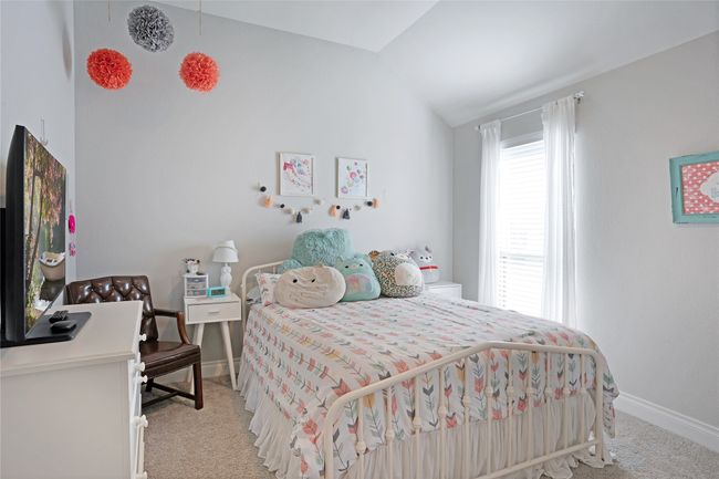 Bedroom featuring light carpet and vaulted ceiling | Image 12