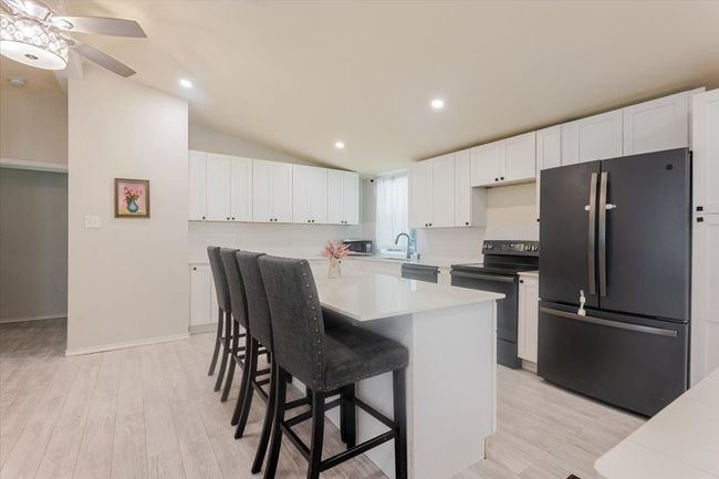 Manufactured Home - Beautiful updated kitchen with Quartz countertops and black stainless steel appliances. | Image 12