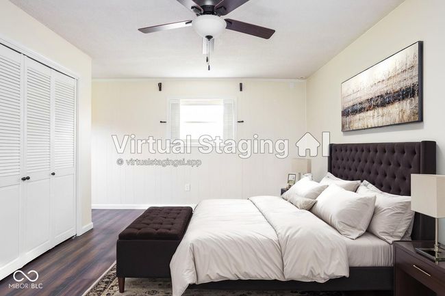 unfurnished bedroom featuring dark wood-style floors, two closets, and a ceiling fan | Image 27